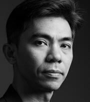 KWR Arcturus, a science fiction author specializing in architectural science fiction and bureaucratic horror. A high-contrast, black and white portrait emphasizing a mysterious and institutional aesthetic.